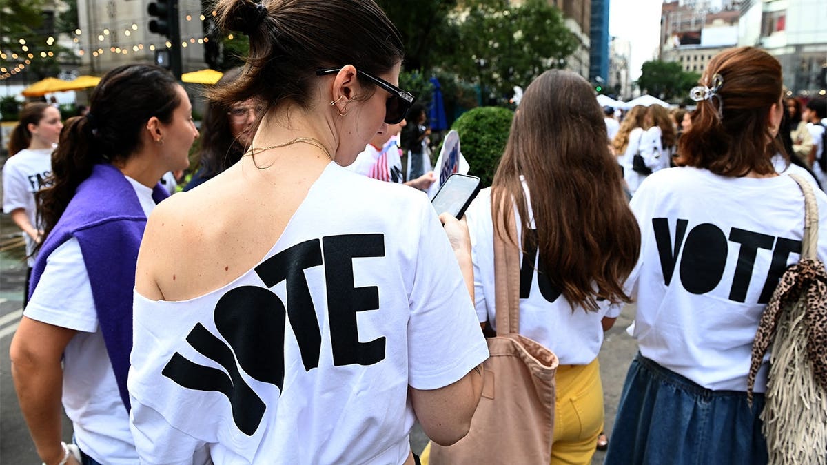 People wearing Vote t-shirts attending a rally during Fashion Week in New York City