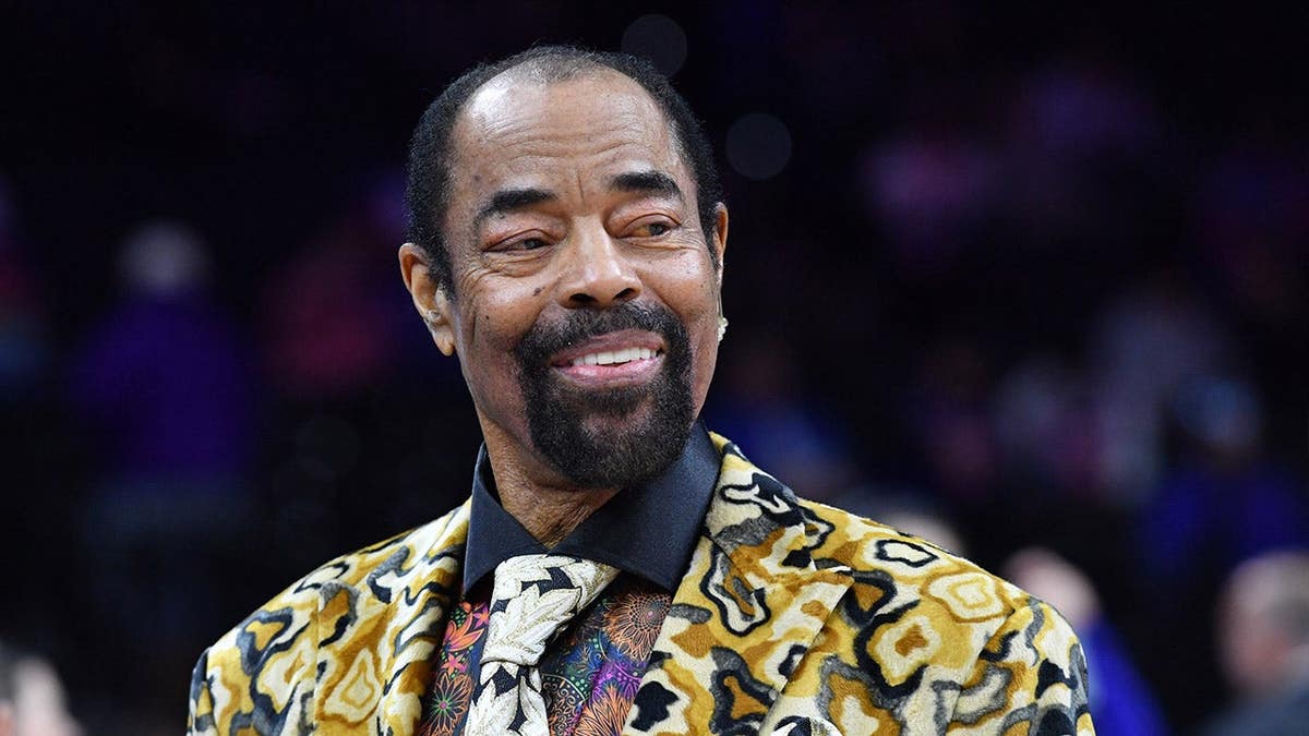 Walt Frazier standing on the basketball court at Wells Fargo Center