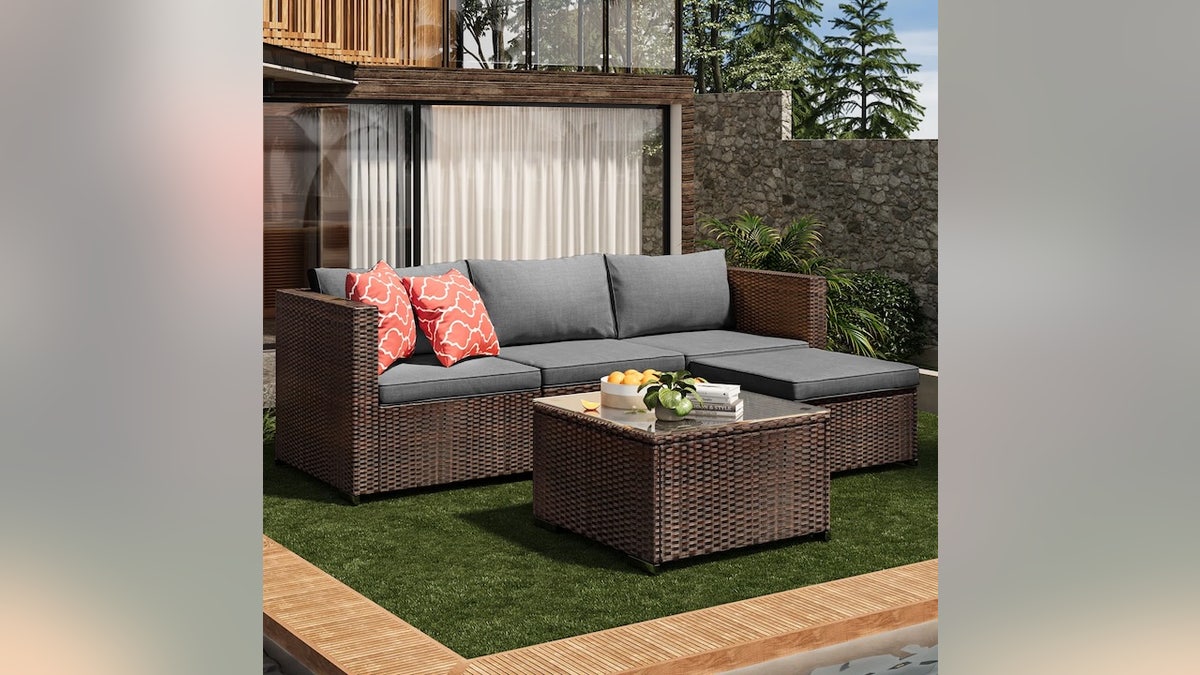 This plush couch has a movable ottoman. 