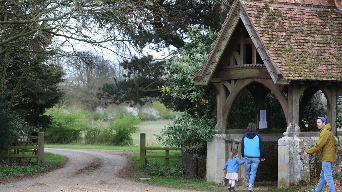 Visitors walking past lane near Wolverton church on Sandringham estate