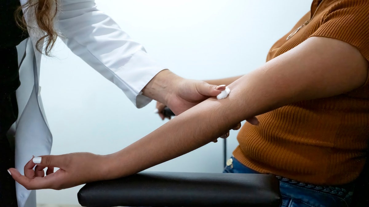 Woman donating blood at doctor's office