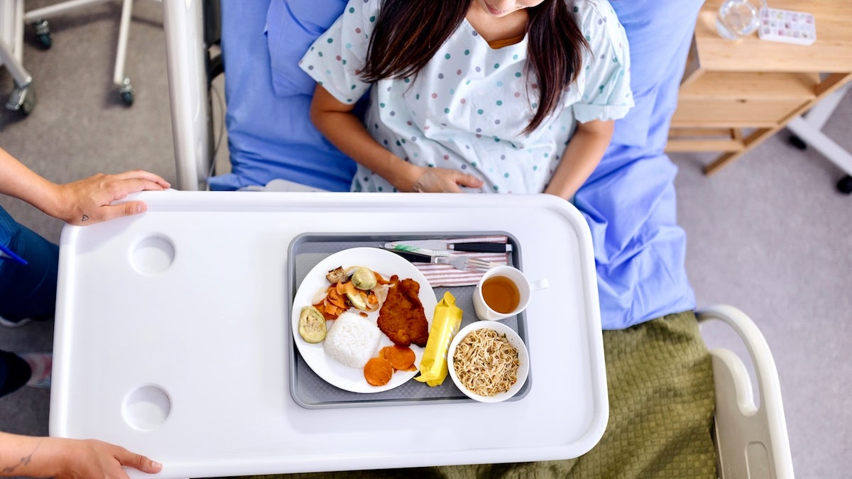 Woman eating meal in hospital