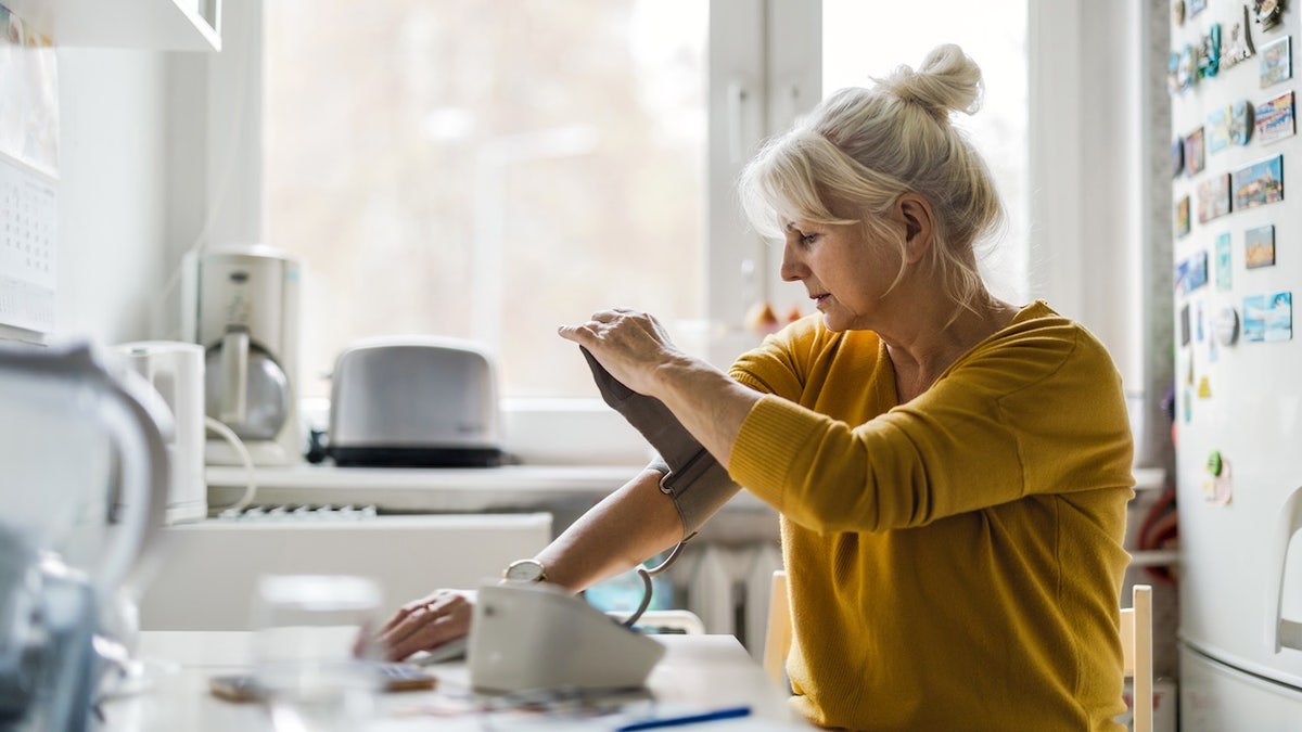 Woman taking her blood pressure