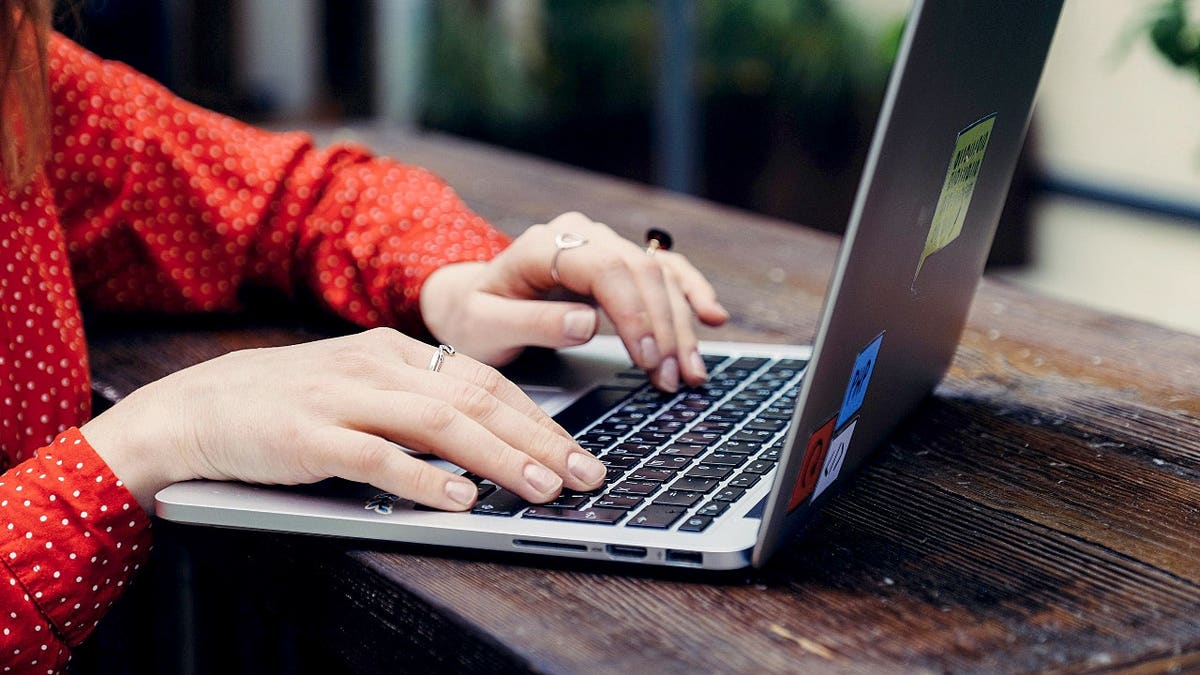 A woman typing on a computer