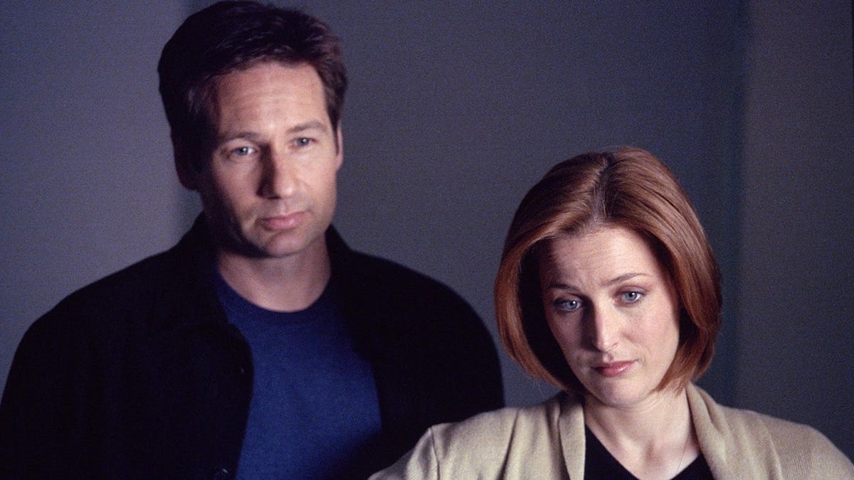 Agents Mulder and Scully standing together in a scene from The X-Files