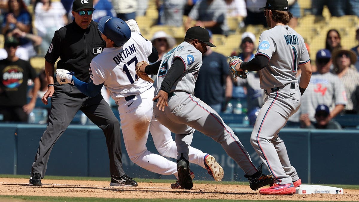 Xavier Edwards tagging Shohei Ohtani out at first base at Dodger Stadium
