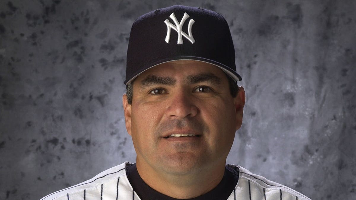 Yankees coach Tom Nieto wearing a team jacket and cap