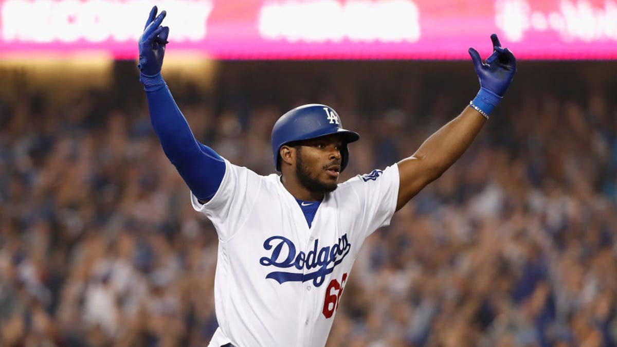 Yasiel Puig running to first base celebrating a home run at Dodger Stadium