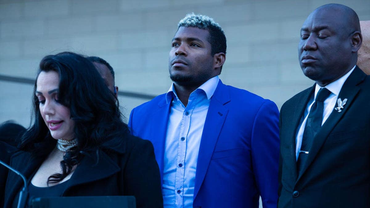 Yasiel Puig standing with agent Lisette Carnet and attorney Zen Crump outside federal courthouse in Los Angeles