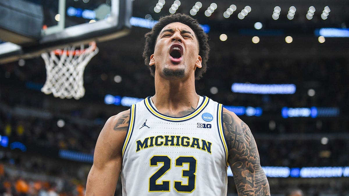 Yaxel Lendeborg reacting after being fouled and scoring in a basketball game.