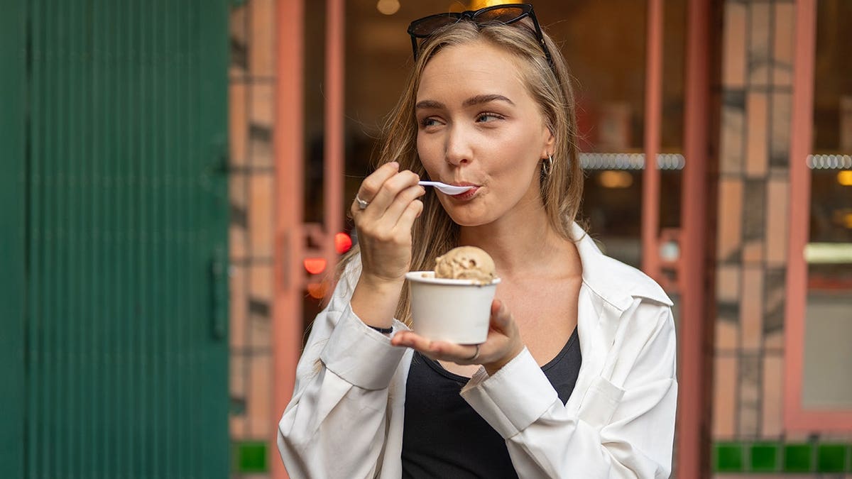 Young tourist eating ice cream in Bangkok city