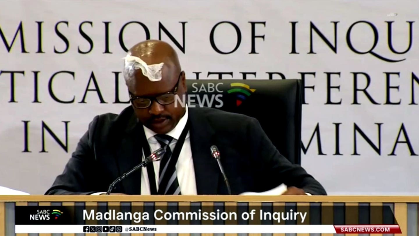 South African ex-police chief gets tissue stuck on forehead while sweating during corruption inquiry