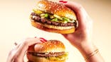 Woman holding two Big Arch burgers