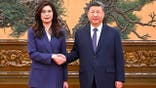 President Xi Jinping, right shakes hands with Kuomintang (KMT) party leader Cheng Li-wun