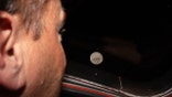 NASA astronaut Reid Wiseman looks at Moon from Orion spacecraft window