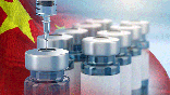 Vaccine bottles with a Chinese flag waving in the background.