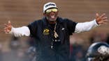 Head coach Deion Sanders reacting on the field at Folsom Field in Boulder, Colorado