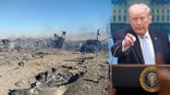 Donald Trump pointing during a press conference next to a photo of aircraft wreckage in a desert.