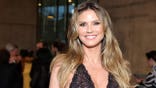 Heidi Klum wearing a plunging black gown at LACMA opening gala in Los Angeles