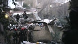 Life under a nightmare of air attack. Israeli security forces and rescue teams working amid the rubble of a residential building.