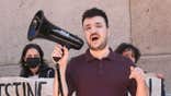 Mahmoud Khalil speaks into a megaphone at a protest outside Columbia University in New York City