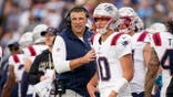 New England Patriots coach Mike Vrabel talking to quarterback Drake Maye at Nissan Stadium