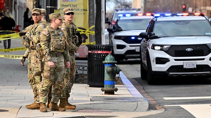 Washington DC national guard on patrol with police vehicles parked