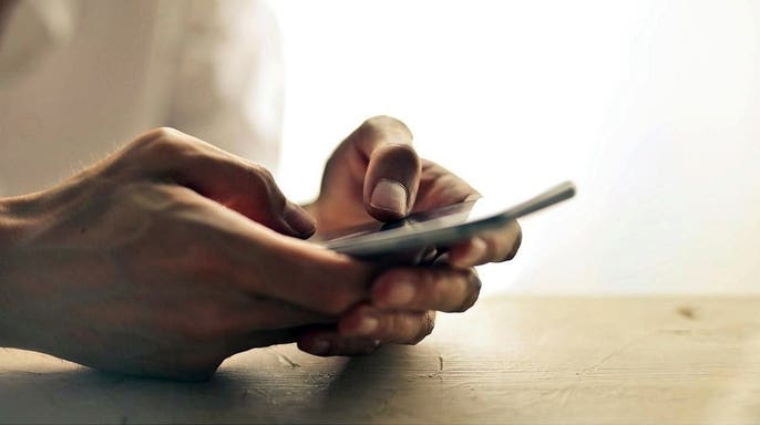 A person scrolling or texting on their phone