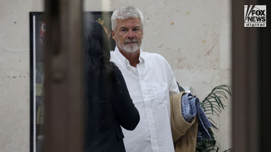 Brian Hooker leaves police station in The Bahamas, with lawyer