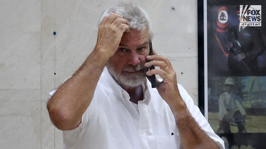 Brian Hooker leaves police station in The Bahamas, with lawyer