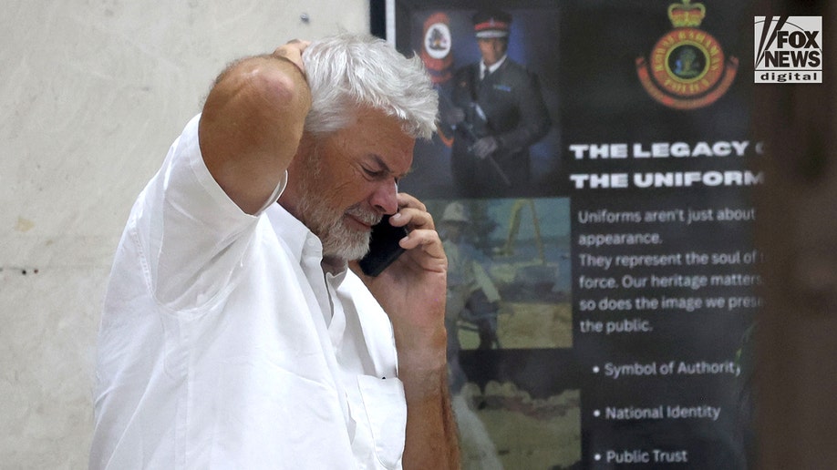 Brian Hooker leaves police station in The Bahamas, with lawyer