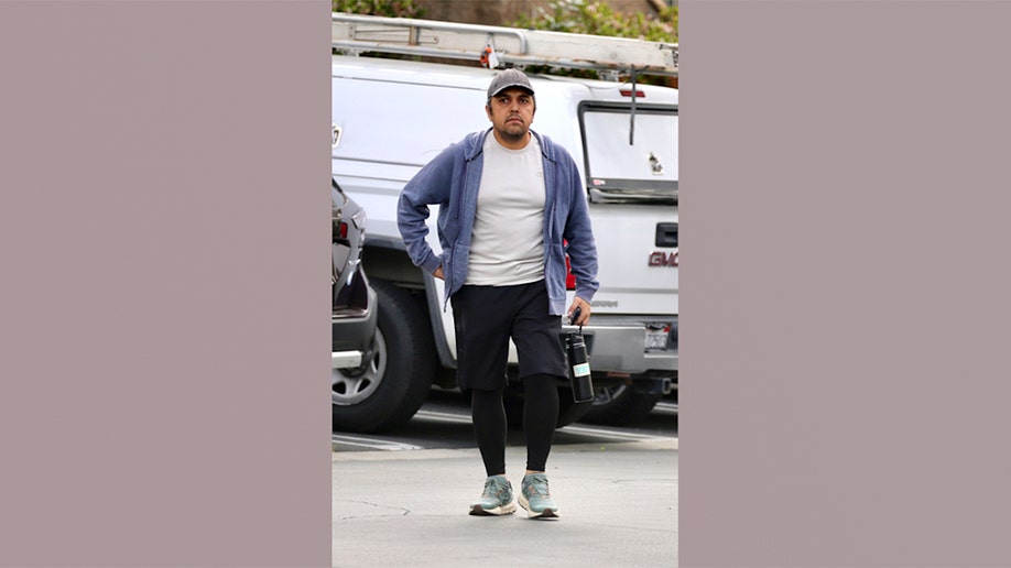 Eissa Hashemi, the son of an Iranian regime leader, walking in a parking lot
