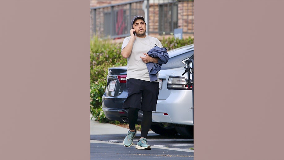 Eissa Hashemi, the son of an Iranian regime leader, walking in a parking lot