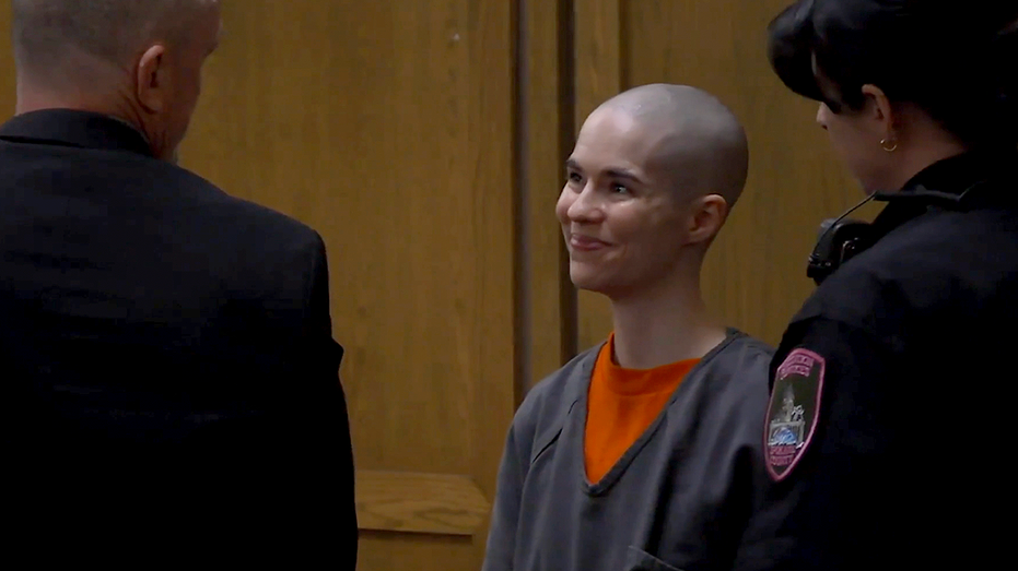 Bald-headed killer smiles as prosecutors reveal what she did before dad walked in