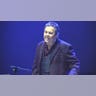 Alan Osmond singing on stage at Wembley Arena in London