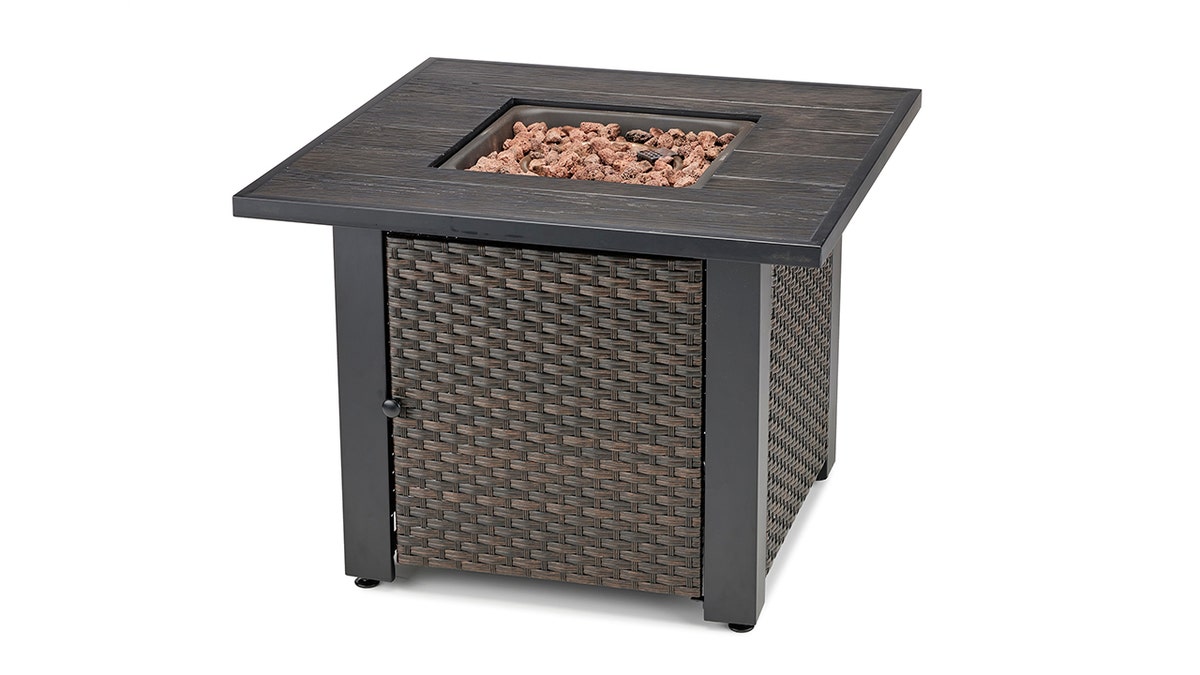 Rest drinks and snacks on the edge of this fire table.