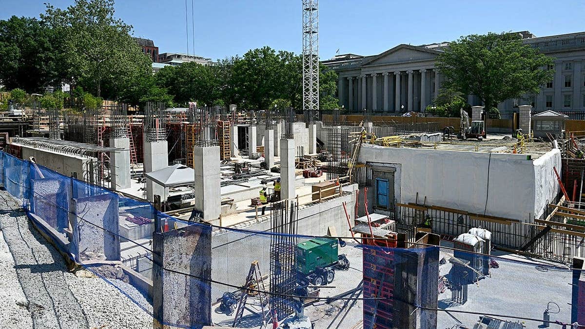 President Donald Trump speaking to the press at the White House with construction site in background