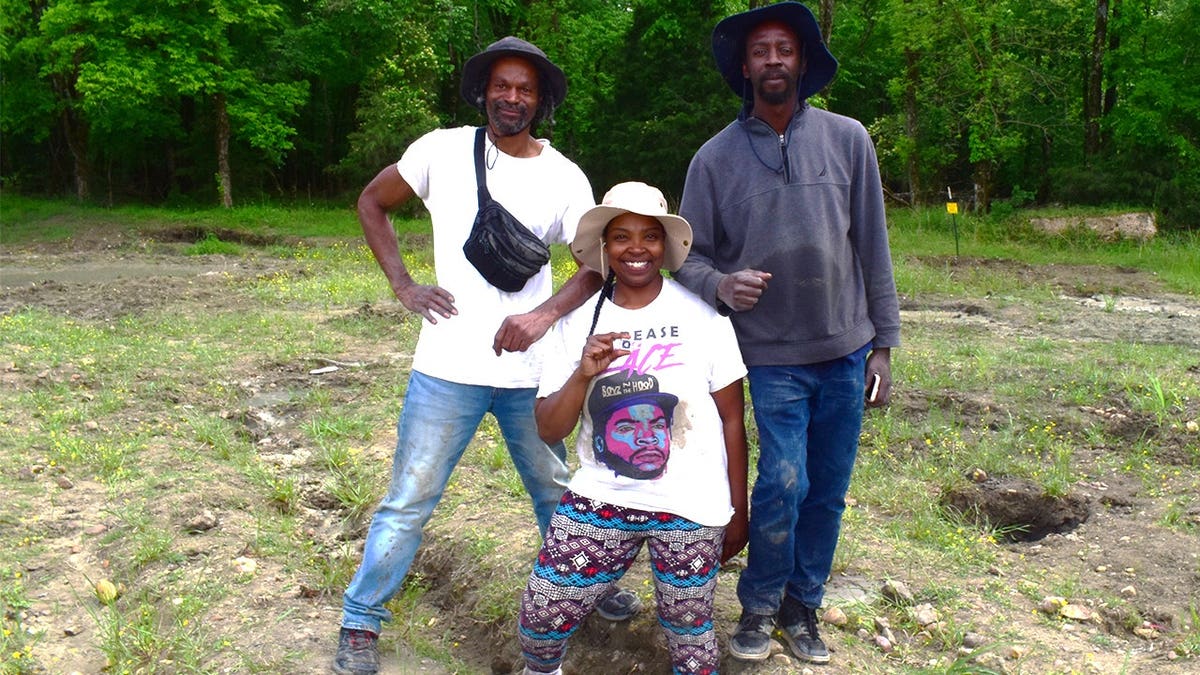 Keshia holding diamond next to her brother, boyfriend