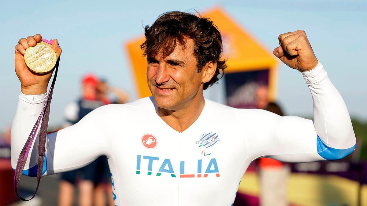 Alessandro Zanardi celebrating with gold medal at Paralympics