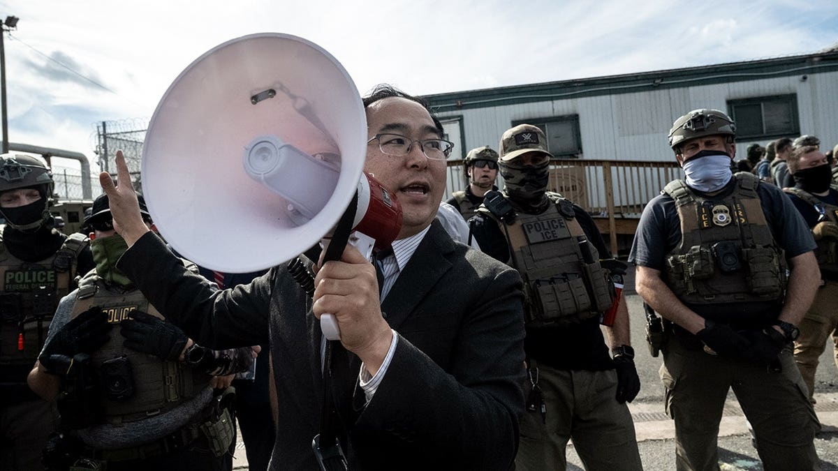 Andy Kim with a bullhorn at Delaney Hall in NJ