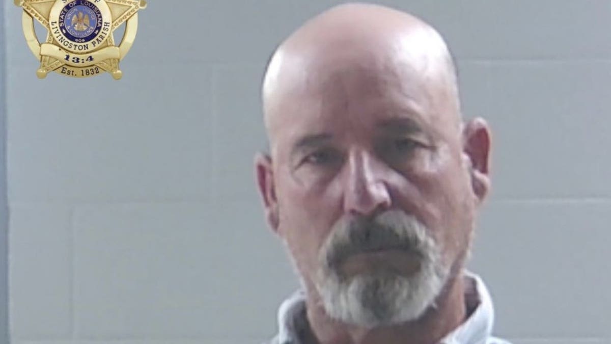 Mugshot of a bald goateed man