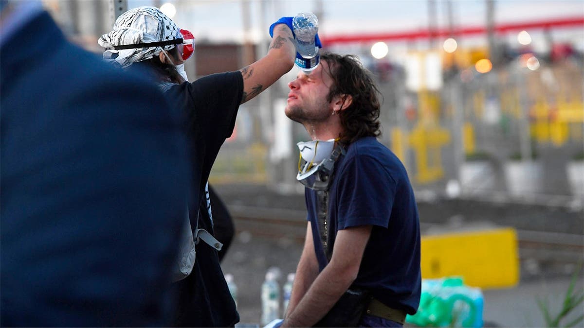 An anti-ICE agitator gets his eye washed out after being exposed to pepper spray
