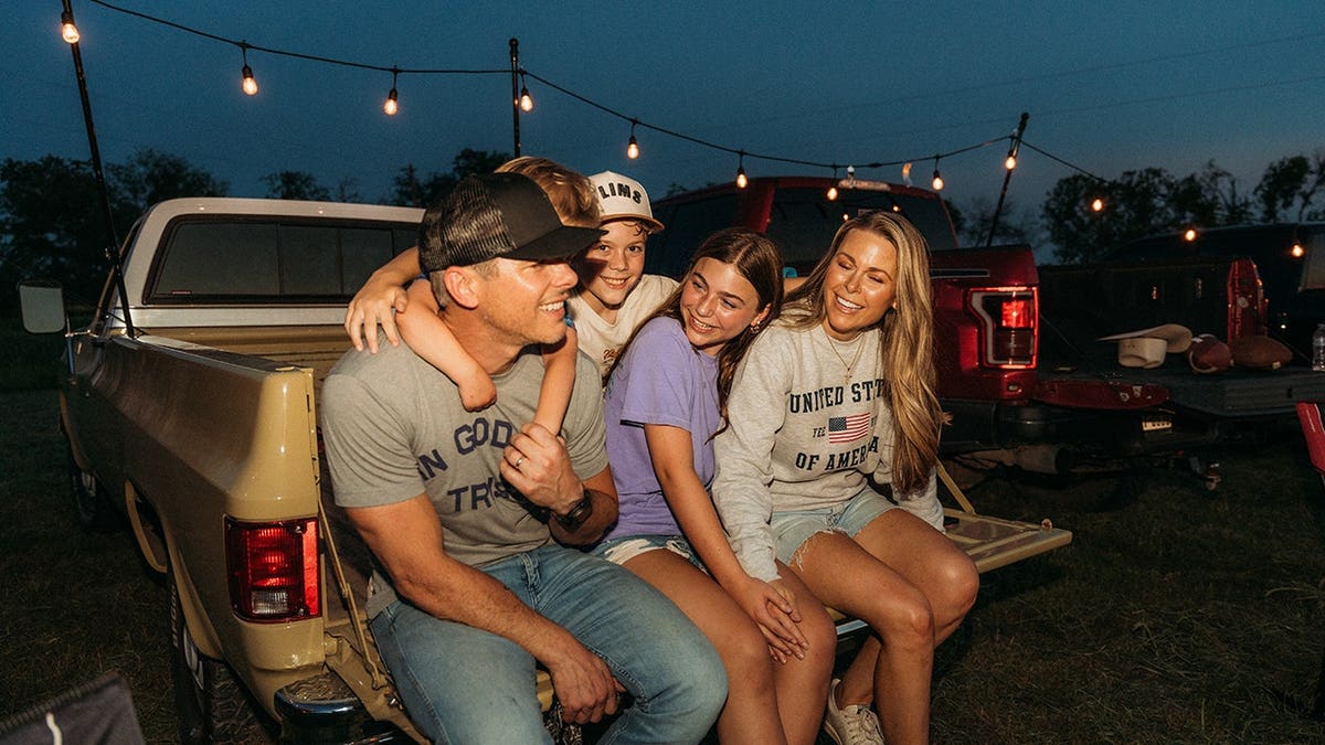 A photo of the Granger Smith family smiling and enjoying being together outside.