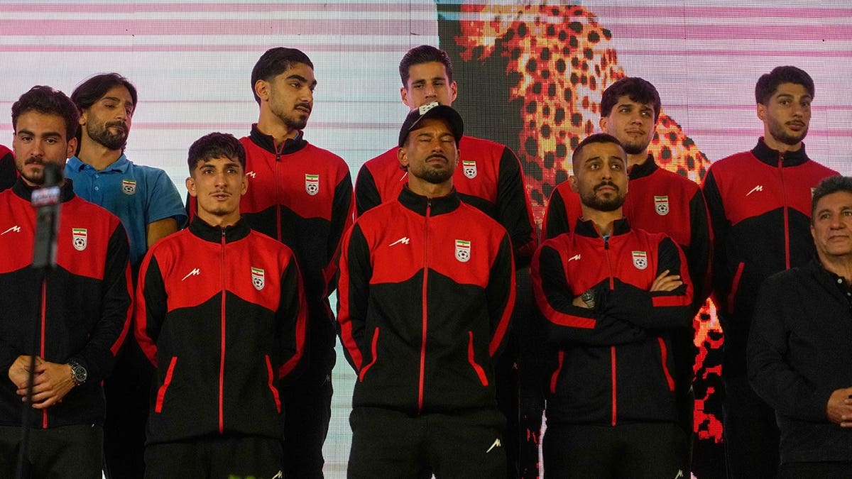 Iran national soccer team players standing on a stage