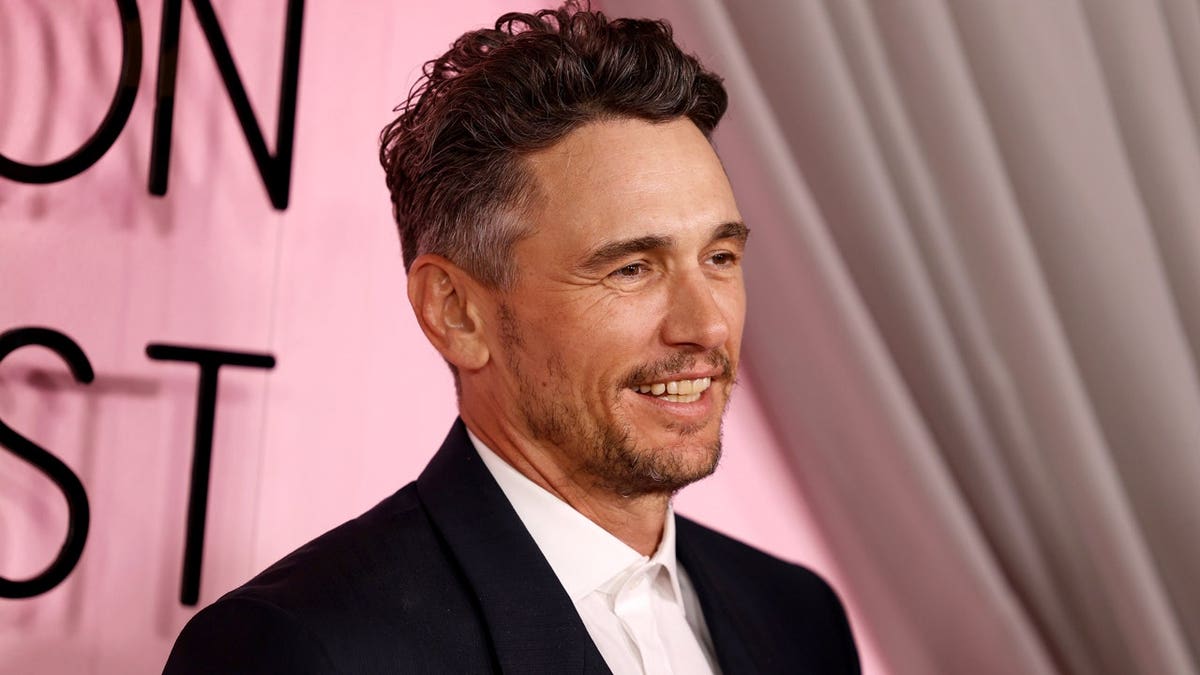 James Franco in front of a pink background
