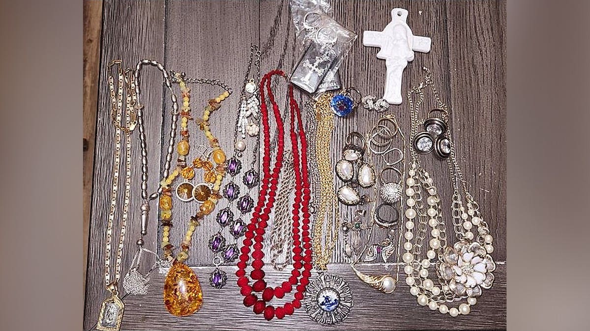 Various necklaces, rings, earrings and jewelry were placed on the table as evidence in a theft investigation.
