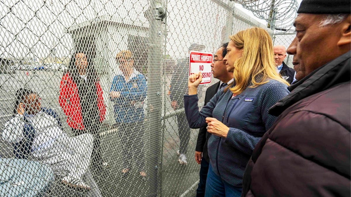 New Jersey Governor Mikie Sherrill and Sen. Andy Kim, D-N.J., stand outside Newark, New Jersey's Delaney Hall detention center during a protest