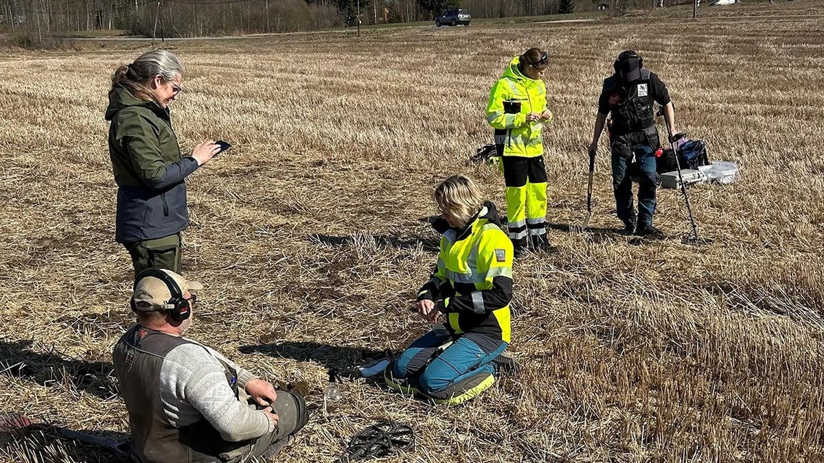 Researchers standing at site