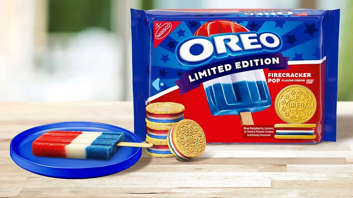 A package of Oreo Firecracker Pop cookies is shown on a wooden table next to a red, white and blue ice pop.