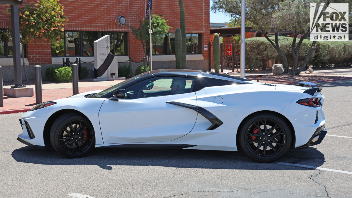 Pima County Sheriff Chris Nanos driving a white Corvette in the PCSD parking lot in Tucson, Arizona